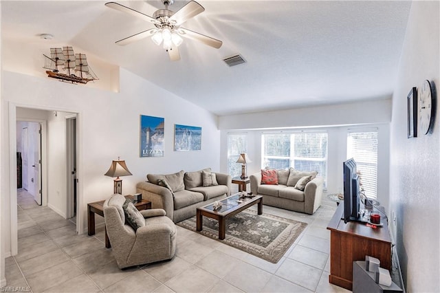 tiled living room with lofted ceiling and ceiling fan