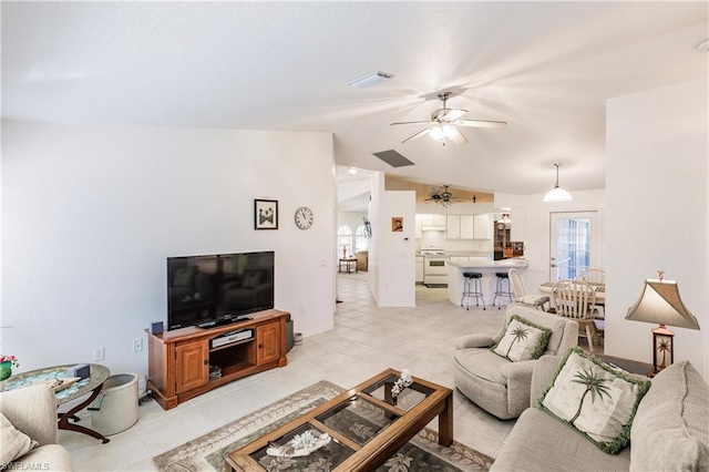 tiled living room featuring ceiling fan