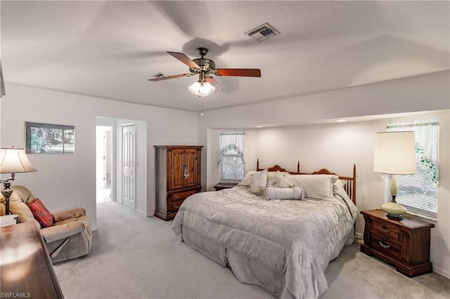 carpeted bedroom featuring ceiling fan and multiple windows