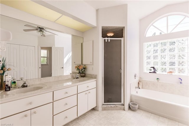 bathroom with plus walk in shower, tile floors, ceiling fan, and dual bowl vanity