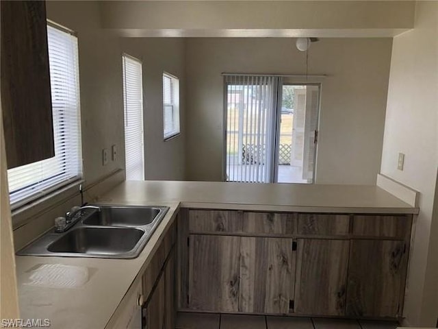 kitchen with plenty of natural light, tile floors, and sink