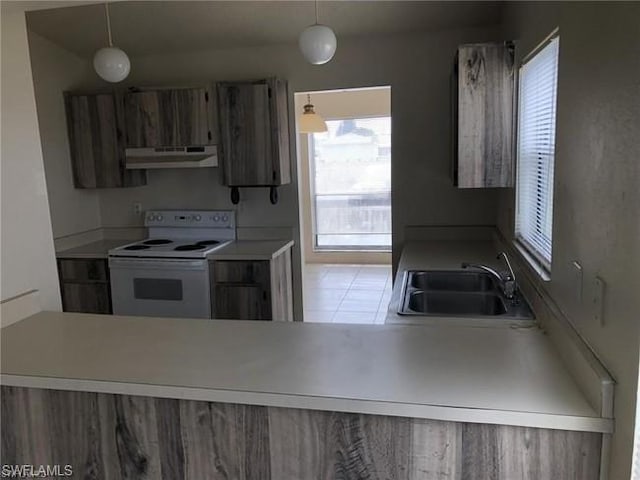 kitchen featuring white range with electric stovetop, light tile floors, decorative light fixtures, fume extractor, and sink