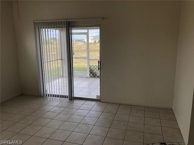 tiled spare room featuring a healthy amount of sunlight