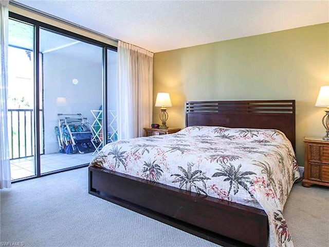 bedroom with light carpet, a wall of windows, and access to exterior