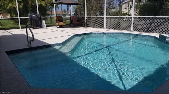 view of pool featuring a patio area and glass enclosure