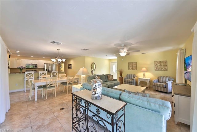 living room featuring light tile flooring and ceiling fan with notable chandelier