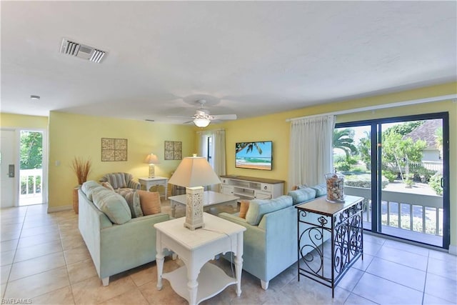 living room with ceiling fan and light tile flooring