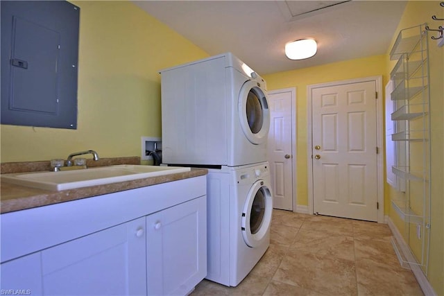 laundry room with washer hookup, sink, light tile floors, stacked washer and clothes dryer, and cabinets