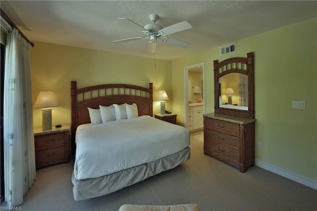 carpeted bedroom featuring ensuite bathroom and ceiling fan