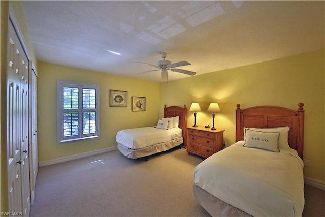 carpeted bedroom with a closet and ceiling fan