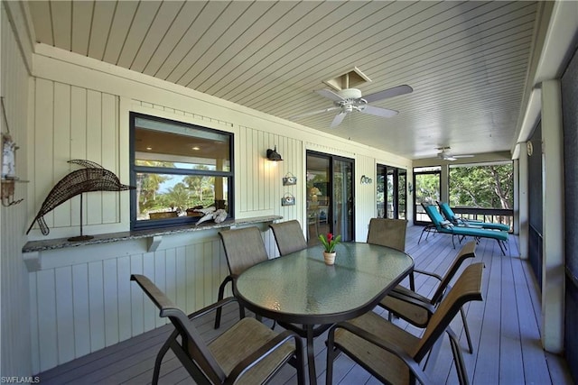 sunroom / solarium featuring french doors, wood ceiling, and ceiling fan