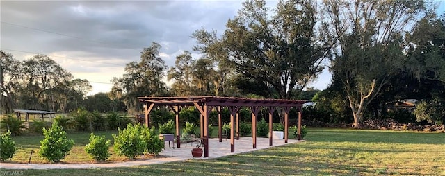 view of property's community with a lawn and a pergola