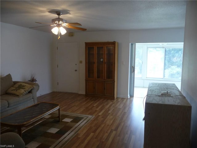 unfurnished living room with ceiling fan and dark hardwood / wood-style floors