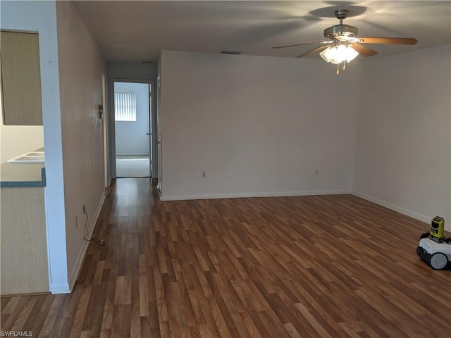 spare room with ceiling fan and dark hardwood / wood-style flooring