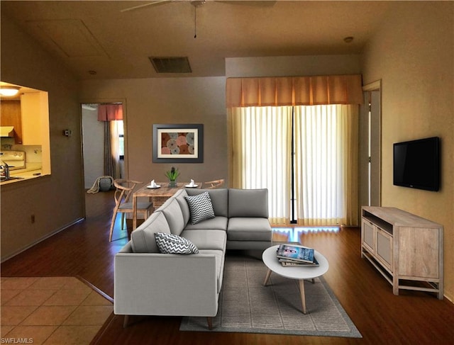 living room featuring lofted ceiling, ceiling fan, and dark hardwood / wood-style flooring