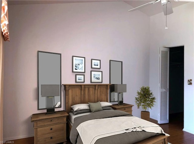 bedroom featuring ceiling fan, dark wood-type flooring, and a towering ceiling