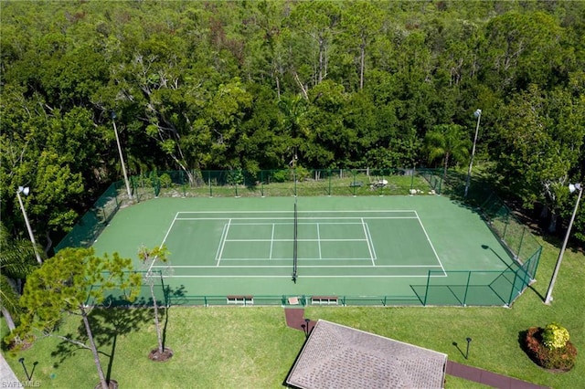 view of sport court with a yard