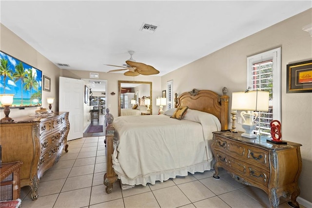 bedroom with ceiling fan and light tile floors