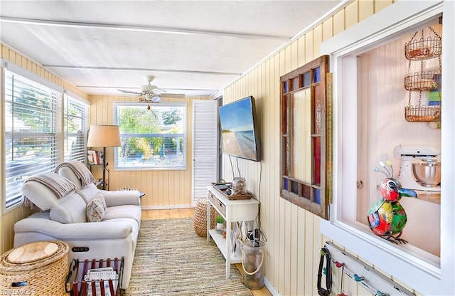 sunroom / solarium featuring ceiling fan