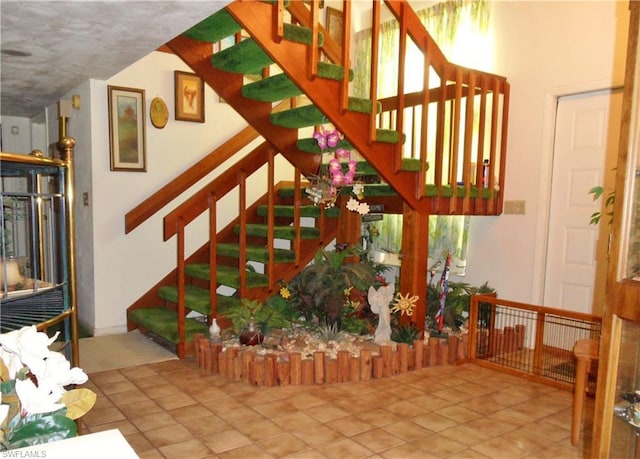 stairway featuring light tile floors