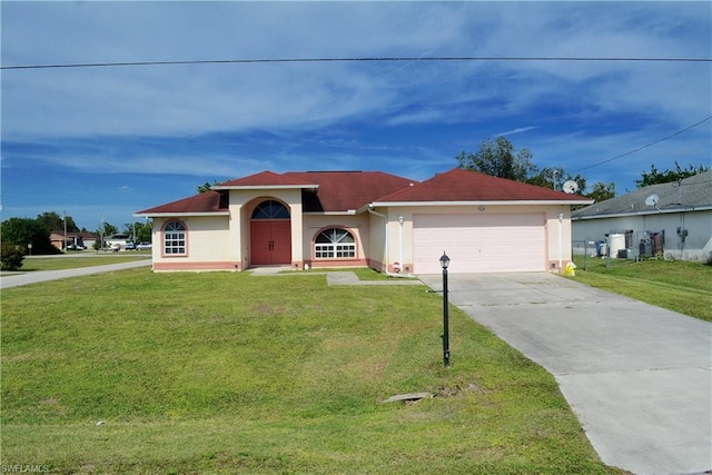 view of front of property featuring a front lawn and a garage