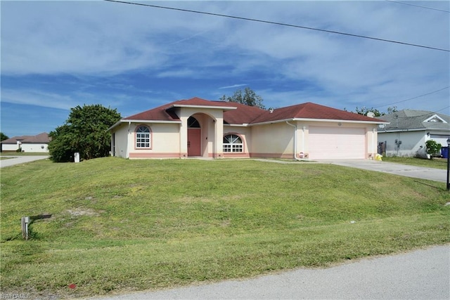 view of front of house featuring a front yard and a garage