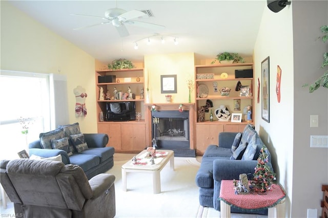 carpeted living room featuring lofted ceiling, ceiling fan, and track lighting