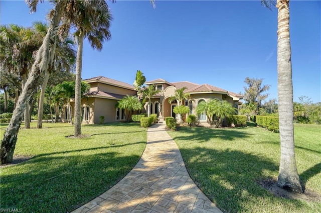 mediterranean / spanish house with a front lawn