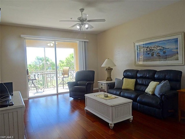 living room featuring ceiling fan and dark wood-type flooring