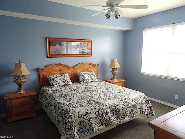 carpeted bedroom featuring multiple windows and ceiling fan