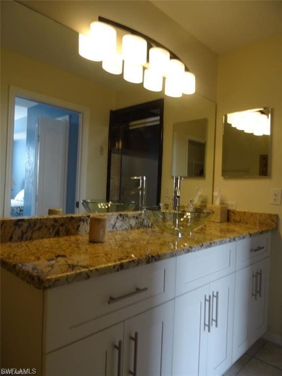 bathroom featuring vanity and tile flooring