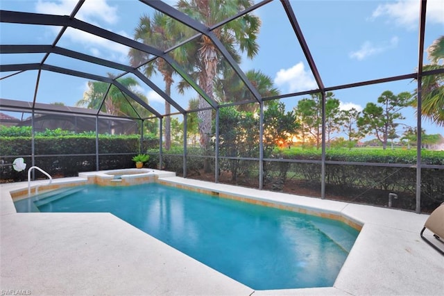 view of swimming pool with a patio area, an in ground hot tub, and a lanai