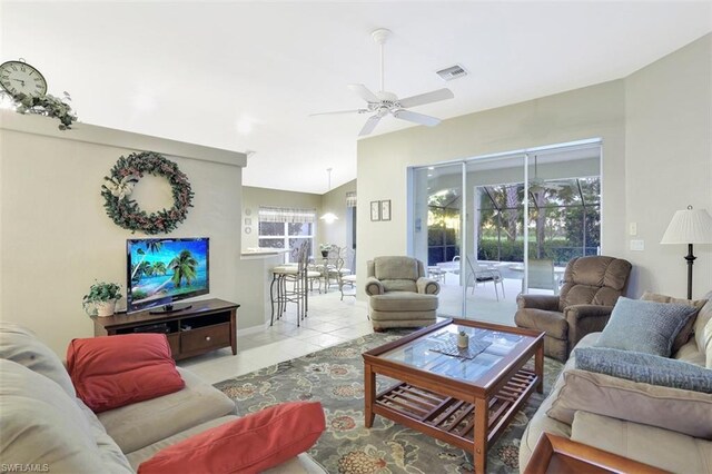 living room featuring ceiling fan and light tile floors