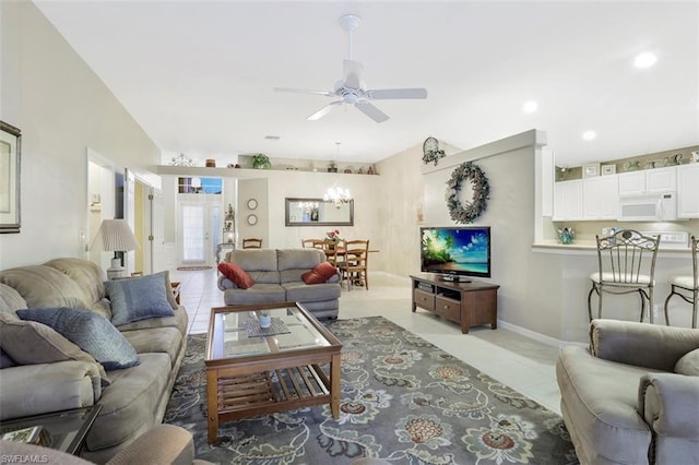 living room featuring ceiling fan with notable chandelier and light tile floors