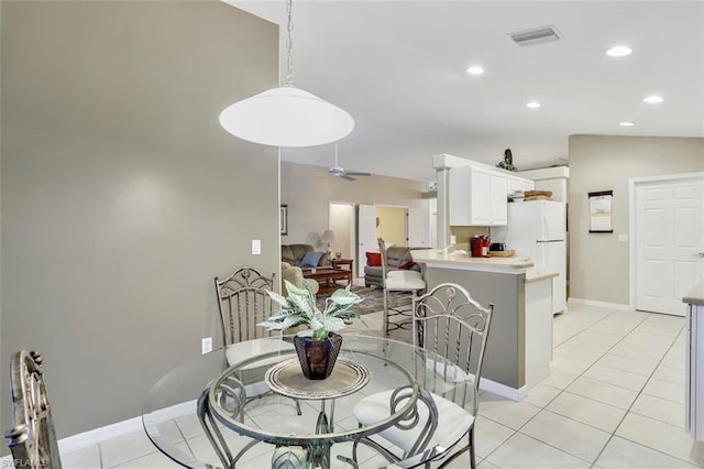 dining space with lofted ceiling, light tile floors, and ceiling fan