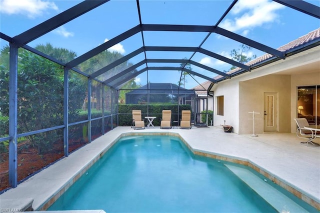 view of pool featuring a patio area and a lanai