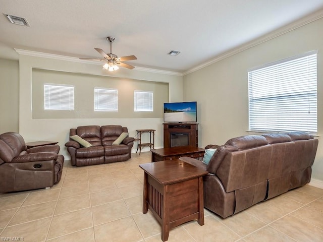 living room with light tile floors, ceiling fan, and ornamental molding