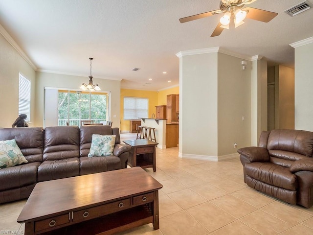 tiled living room with crown molding and ceiling fan with notable chandelier