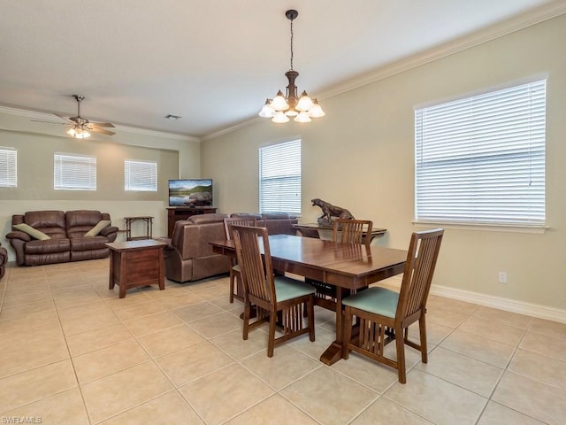 dining area with a healthy amount of sunlight, light tile floors, and ceiling fan with notable chandelier