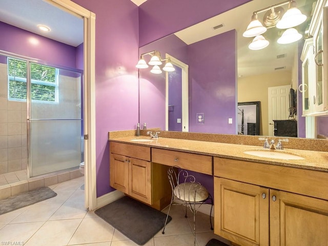 bathroom featuring walk in shower, toilet, vanity with extensive cabinet space, dual sinks, and tile flooring