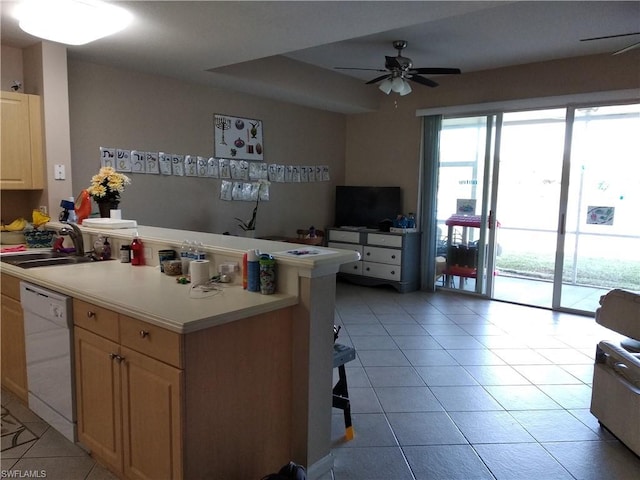 kitchen with white dishwasher, light tile floors, ceiling fan, and sink