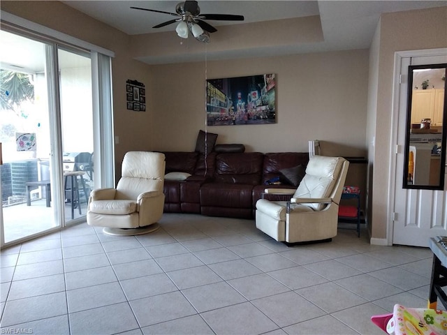 tiled living room with ceiling fan