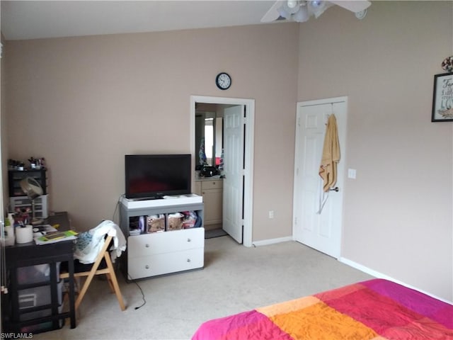 carpeted bedroom with ceiling fan and lofted ceiling