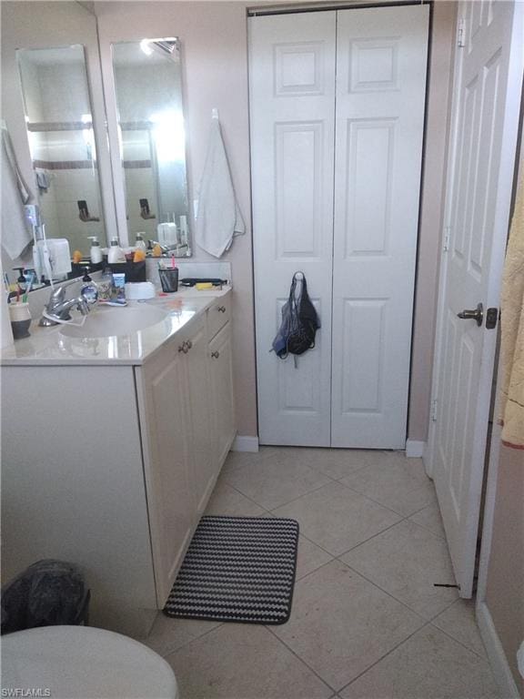 bathroom with tile floors and vanity