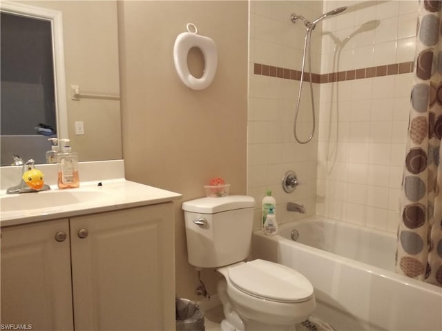 full bathroom featuring vanity, shower / bath combination with curtain, and toilet