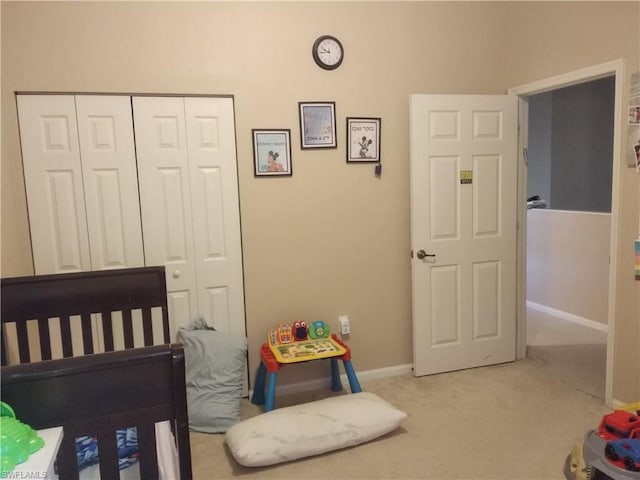 bedroom with light carpet and a closet