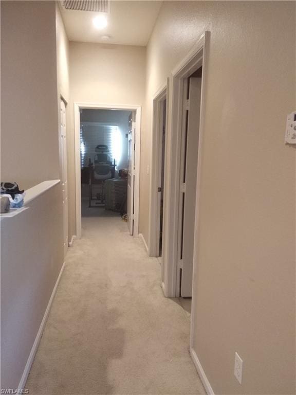 hallway with light colored carpet