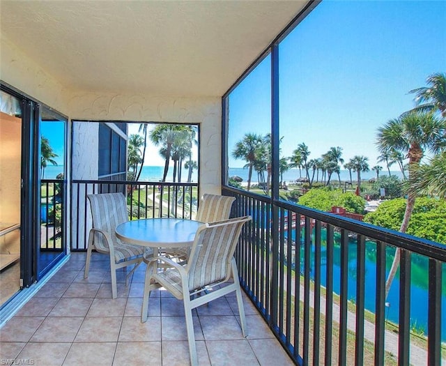 sunroom / solarium with a water view