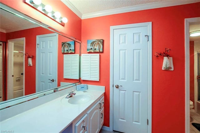 bathroom with vanity, a textured ceiling, crown molding, and toilet