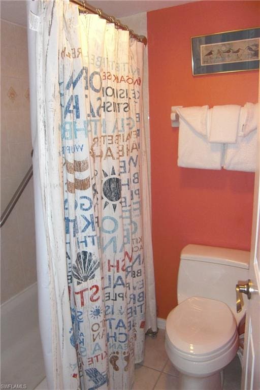 bathroom featuring tile flooring and toilet